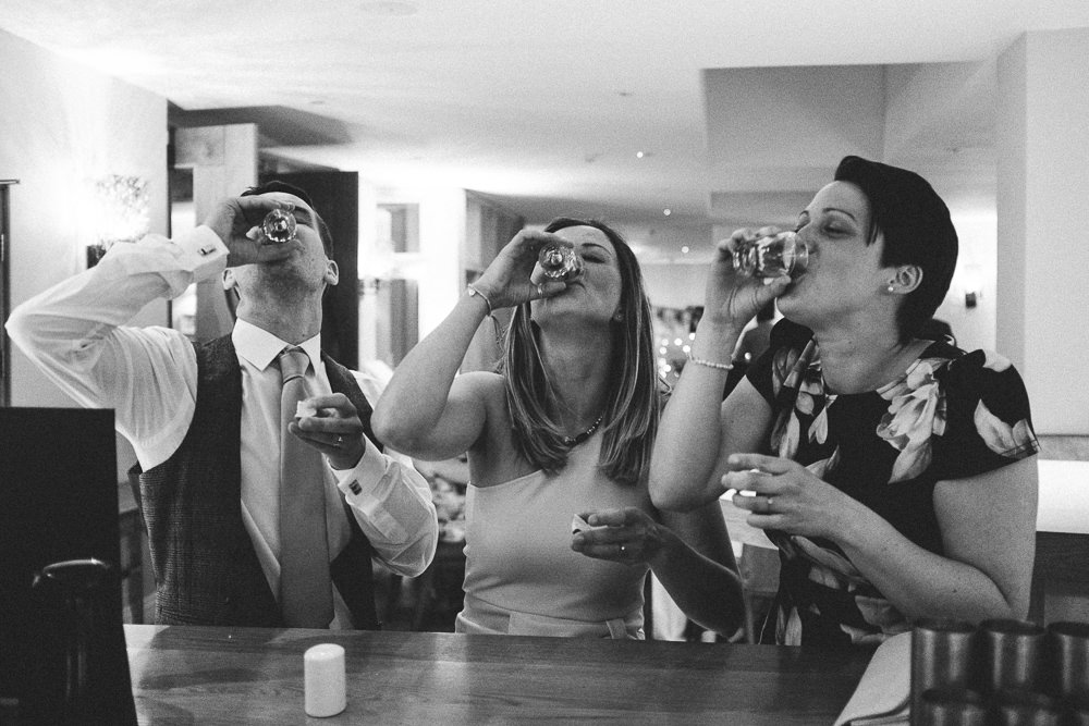 004 GROOM FRIENDS DOING SHOTS AT THE BAR HOLM HOUSE HOTEL PENARTH WEDDING PHOTOGRAPHY